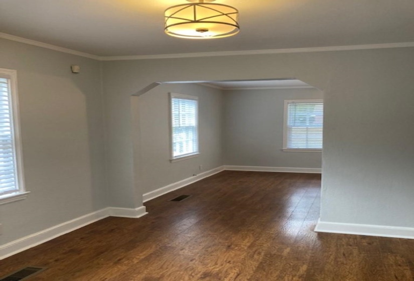 Unfurnished room with ornamental molding and dark hardwood / wood-style flooring