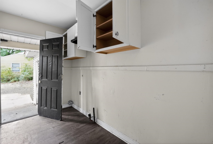 Dark wood-finish flooring with white baseboards