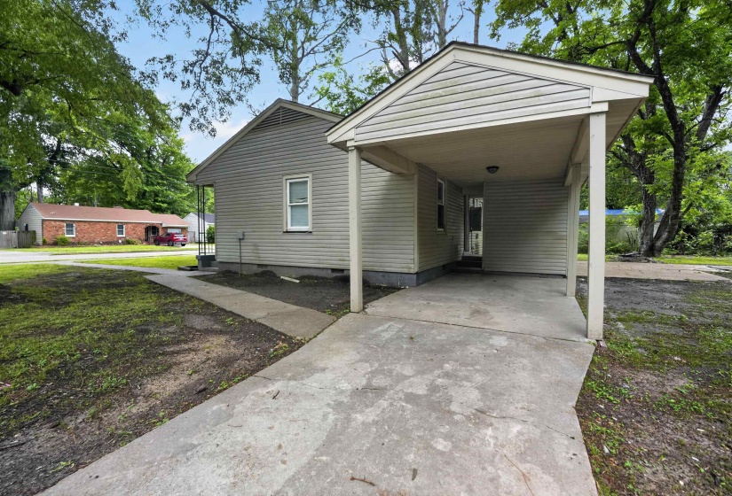 Side-entry carport with concrete flooring