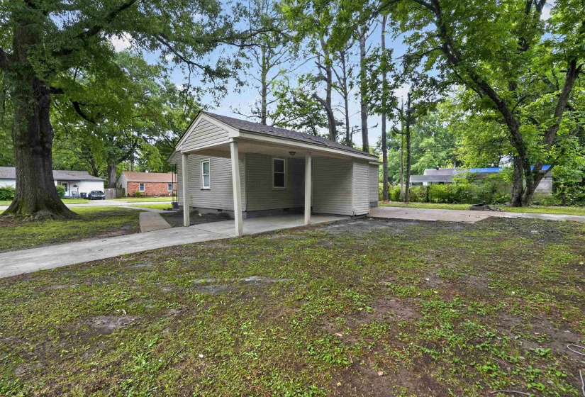 Single-story property with light-colored siding and a covered carport