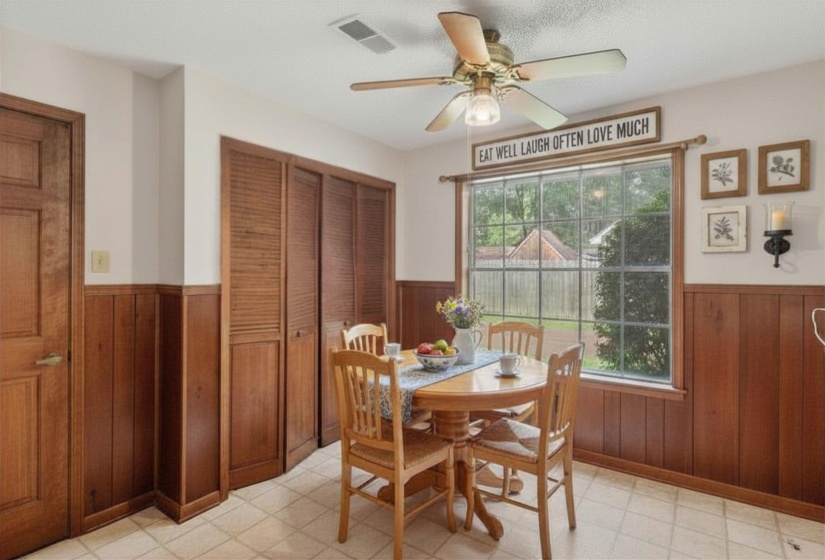Sunny breakfast area with backyard views and convenient kitchen access. (Virtually staged.)