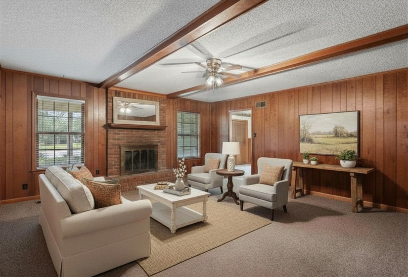 18x17 Den featuring exposed wood beams, paneled walls, and carpet. Fireplace not in working condition. (Virtually staged.)