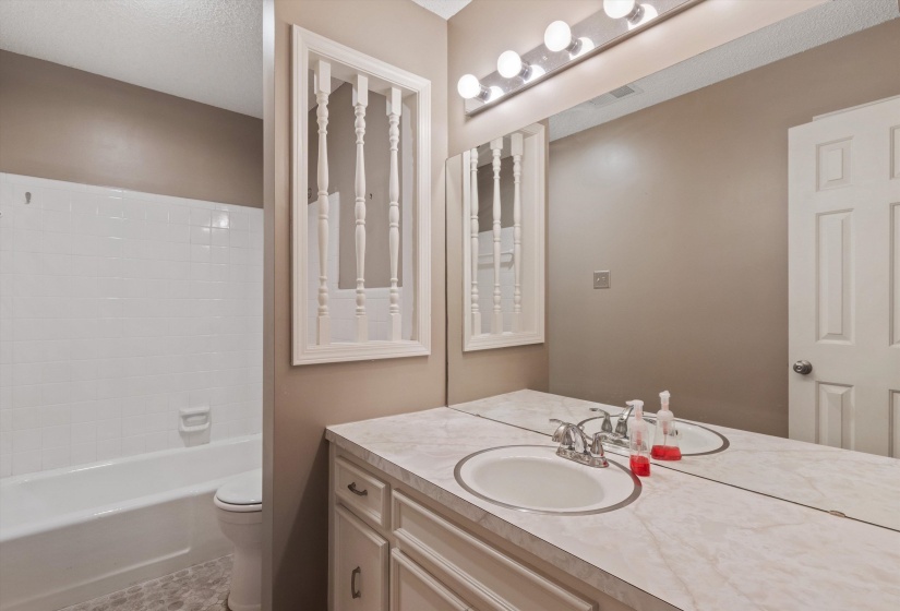 Hall bath with updated tile flooring and tub/shower   combination.