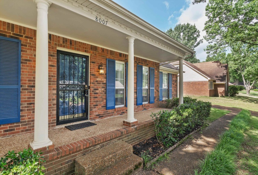 Welcoming covered front porch with classic columns and charming curb appeal.