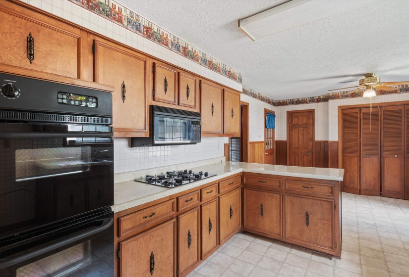 Kitchen features double ovens, gas cooktop, built-in   microwave, KitchenAid dishwasher, 21 cabinets plus   Breakfast Area