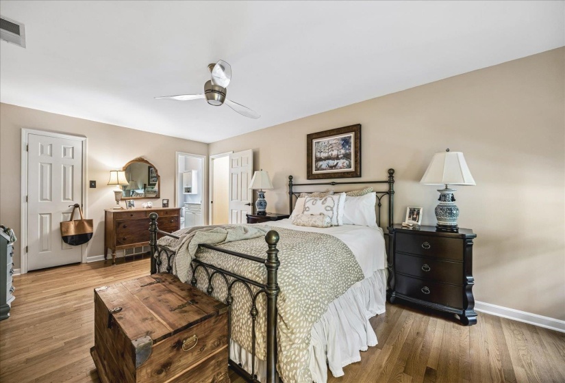 Bedroom featuring wood-finish flooring, neutral wall tones, and white trim