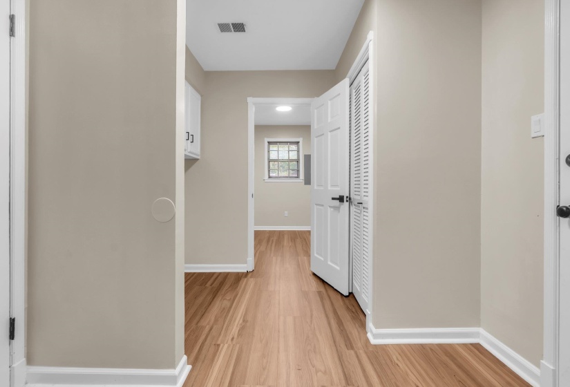 Hallway featuring wood-finish flooring and neutral wall tones