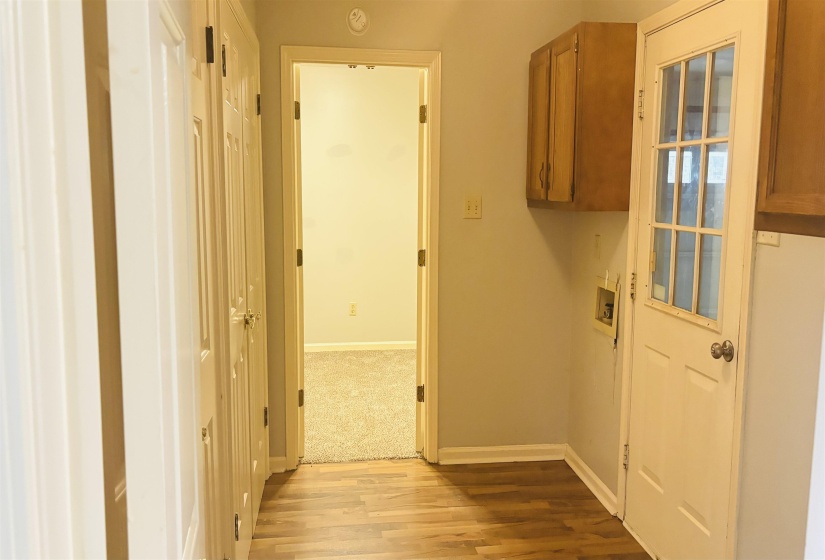 Laminate wood-finish flooring with light gray wall paint