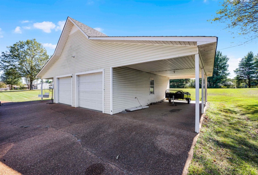 Garage featuring asphalt driveway