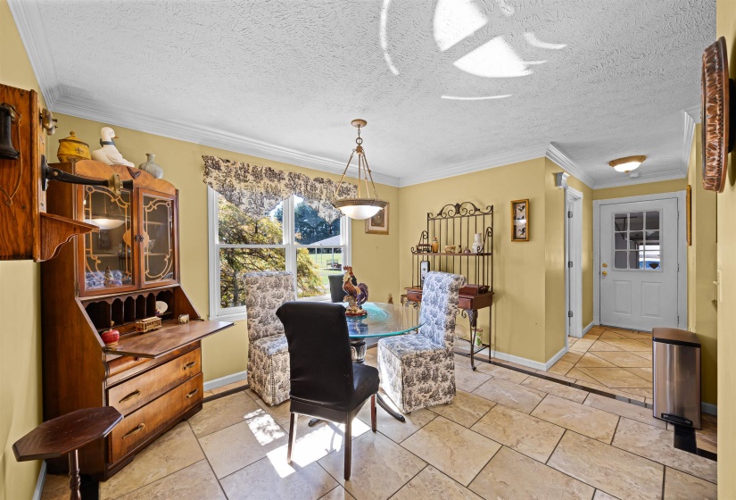 Dining room featuring ornamental molding and a textured ceiling