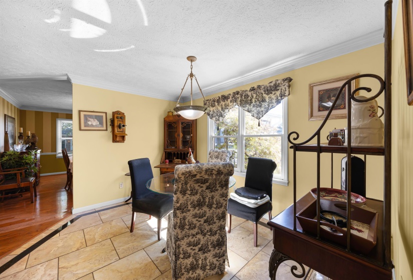 Dining room featuring a textured ceiling and crown molding