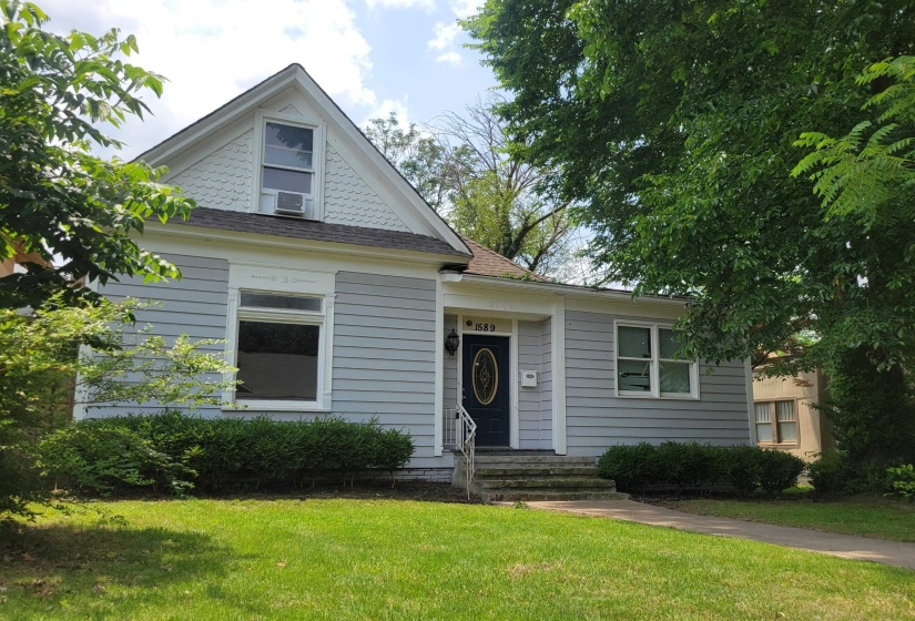 Bungalow-style house featuring a front lawn