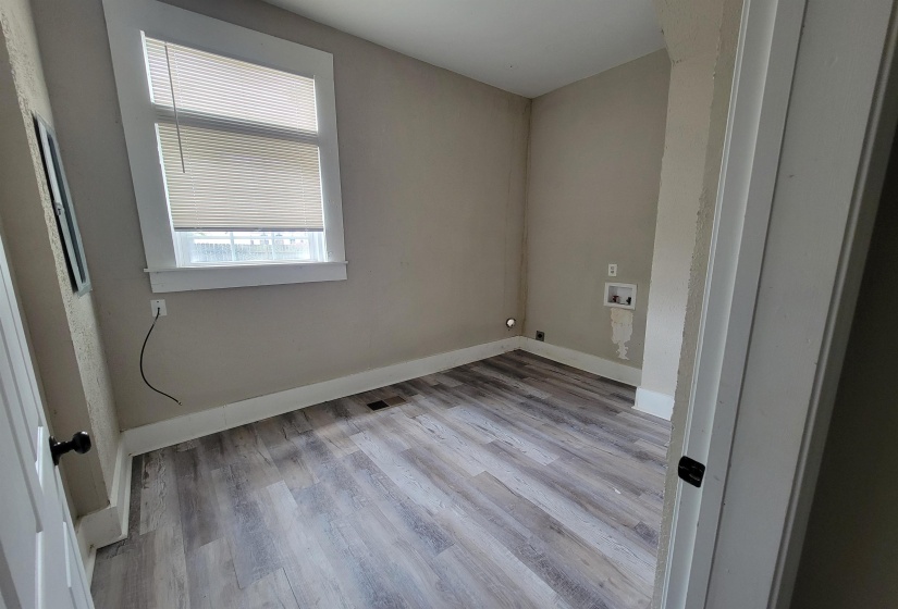 Empty room with wood finished floors and baseboards