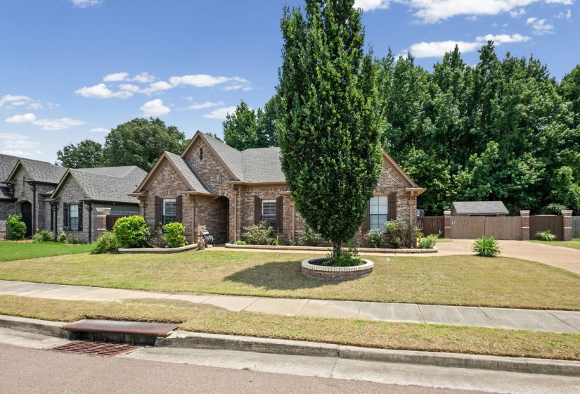 Brick exterior with gabled rooflines, dark shutters, and a covered front entry