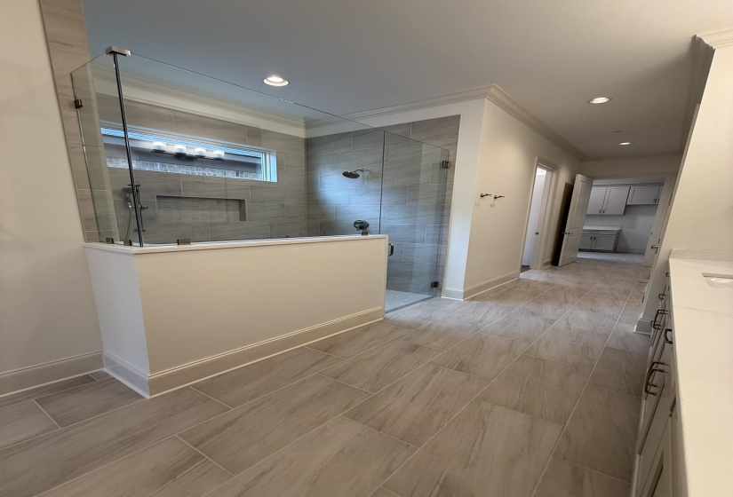 Contemporary shower enclosure featuring clear glass panels and subway tile surround