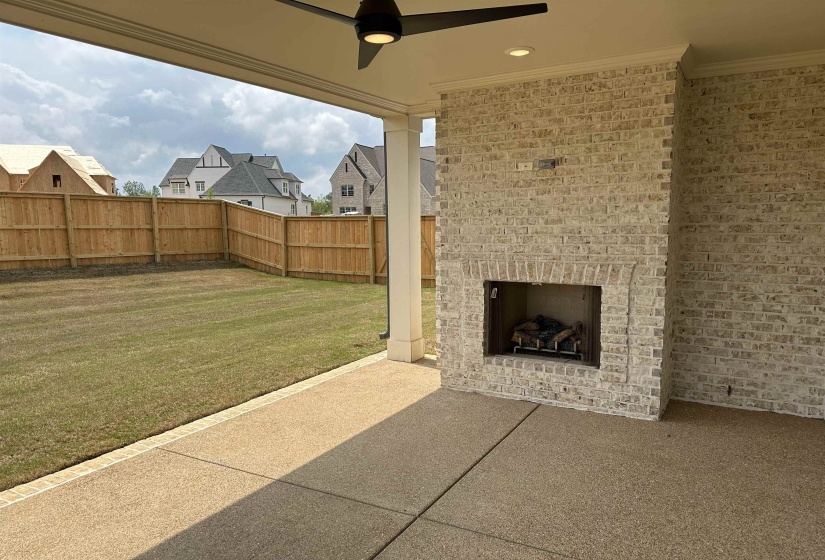 View of patio / terrace with an outdoor brick fireplace and ceiling fan