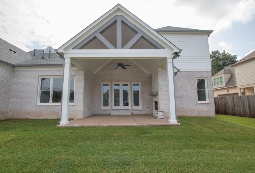 Rear view of property featuring a patio area, a yard, and ceiling fan