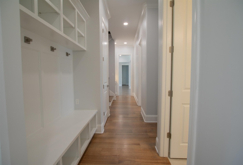 Mudroom with crown molding and hardwood / wood-style floors
