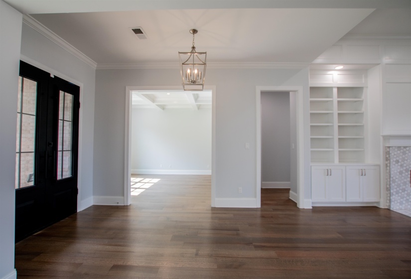 Interior space with a chandelier, french doors, and wood-type flooring