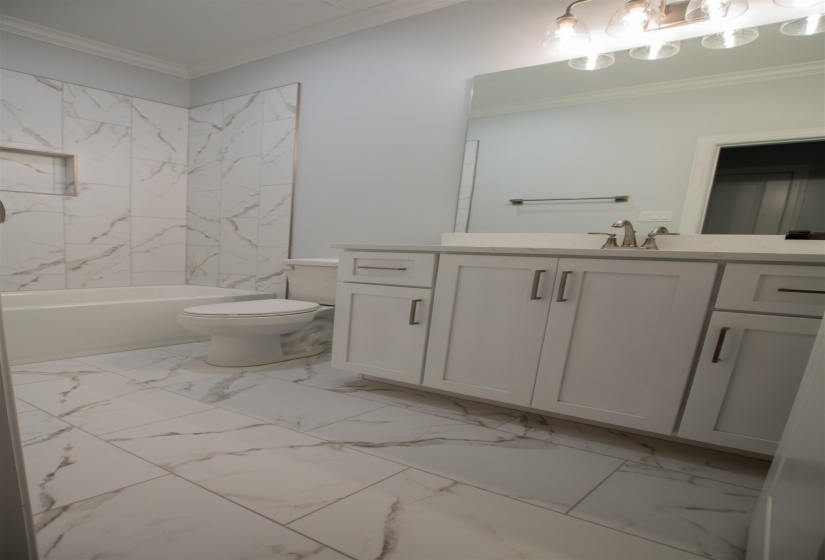 Full bathroom featuring tile patterned floors, toilet, and vanity