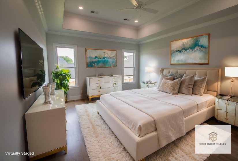 Bedroom with a tray ceiling, wood finished floors, ornamental molding, recessed lighting, and ceiling fan