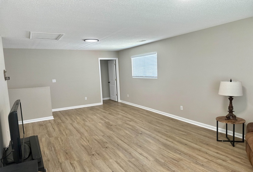 Living room  hardwood / wood-style floors view to 2nd bedroom.