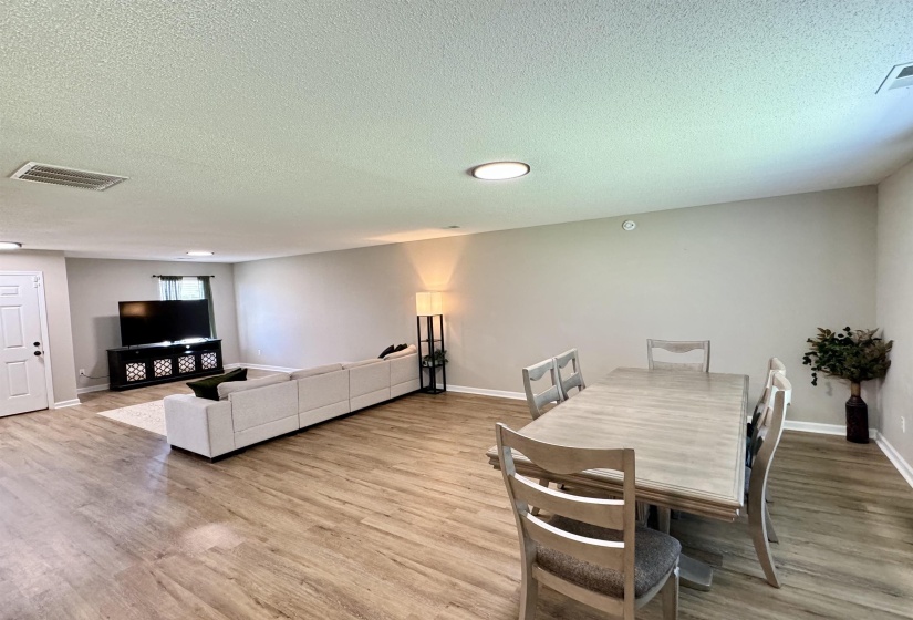 Dining area with a textured ceiling and hardwood / wood-style floors