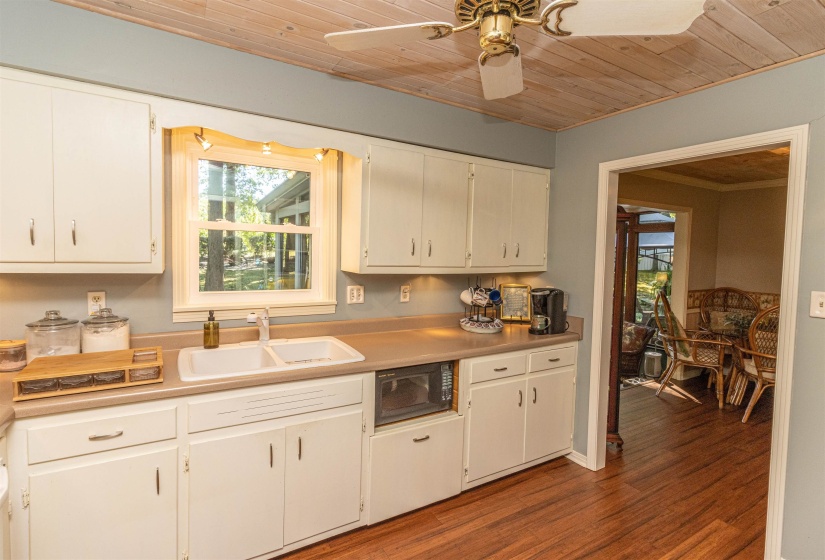 Kitchen with sink, wooden ceiling, ceiling fan, and white cabinetry