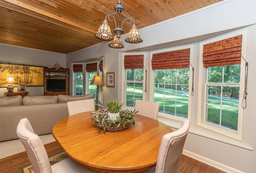 Dining space featuring wood ceiling, wood-type flooring, and a healthy amount of sunlight