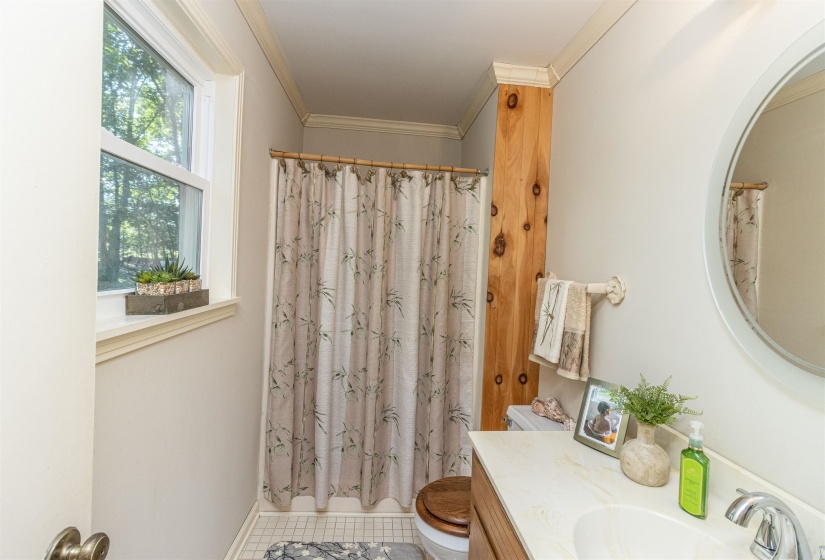 Bathroom with vanity, crown molding, tile patterned flooring, and toilet