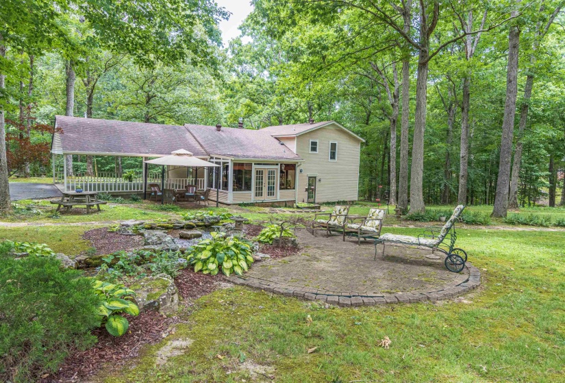 Back of property featuring a yard and a patio