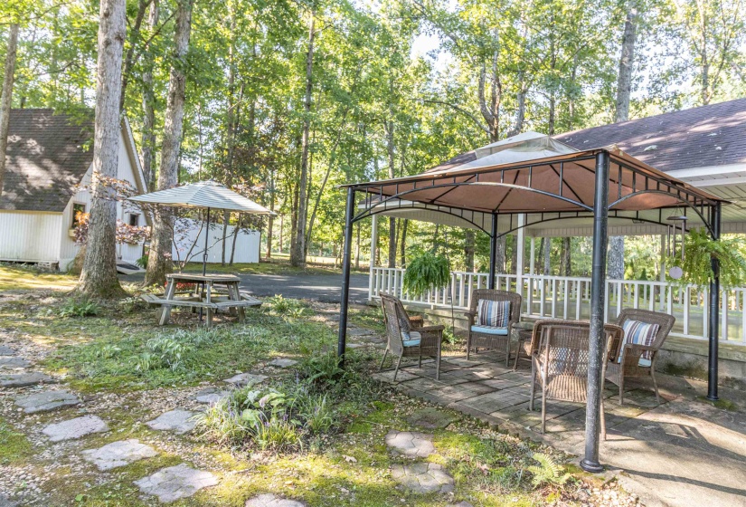 View of yard with a patio, a storage unit, and a gazebo