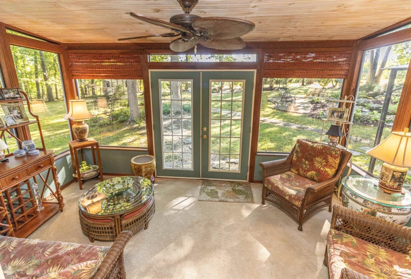 Sunroom / solarium with a wealth of natural light, ceiling fan, french doors, and wood ceiling