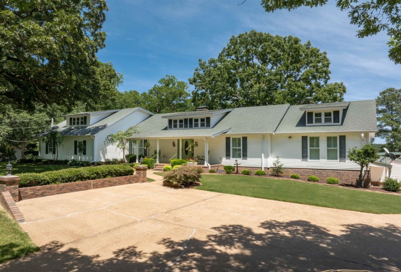 View of front of house with a porch and a front lawn