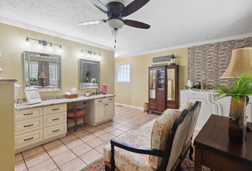 Bathroom featuring tile patterned flooring, crown molding, and ceiling fan