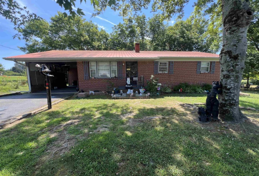 Ranch-style home with a carport and a front lawn