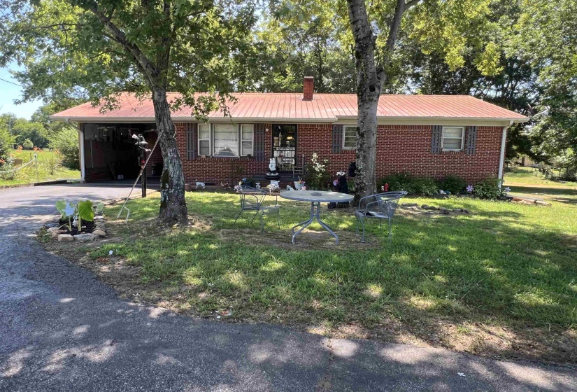 Single story home featuring a carport and a front yard