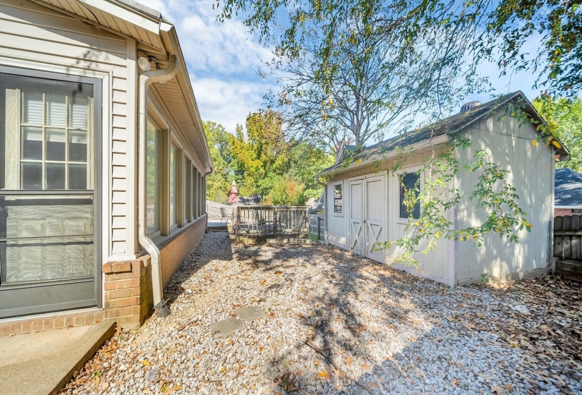 View of side of property with a storage shed