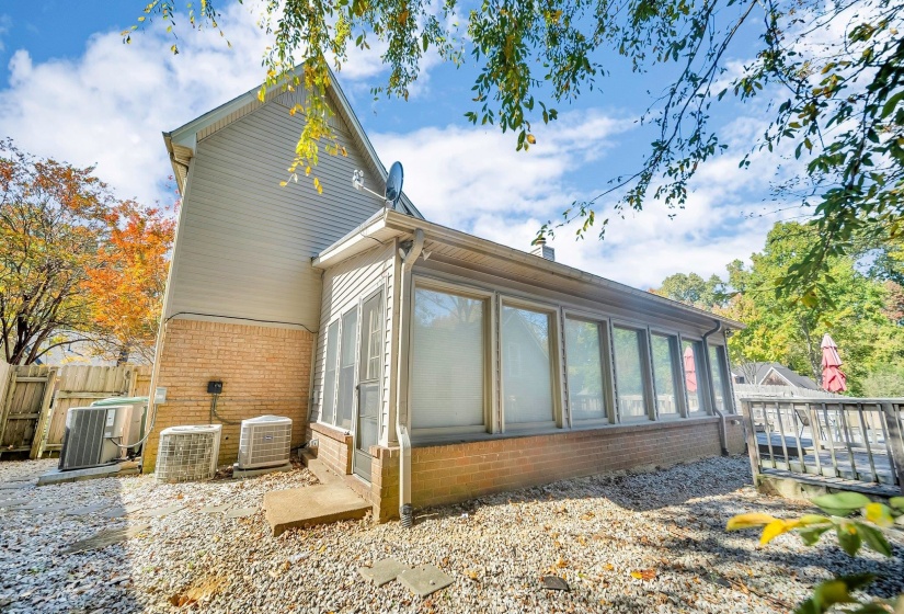 Rear view of property featuring central AC and a deck