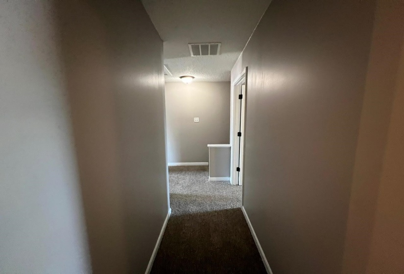 Corridor featuring carpet floors