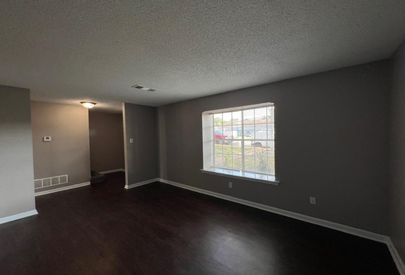Unfurnished room featuring a textured ceiling and hardwood / wood-style flooring