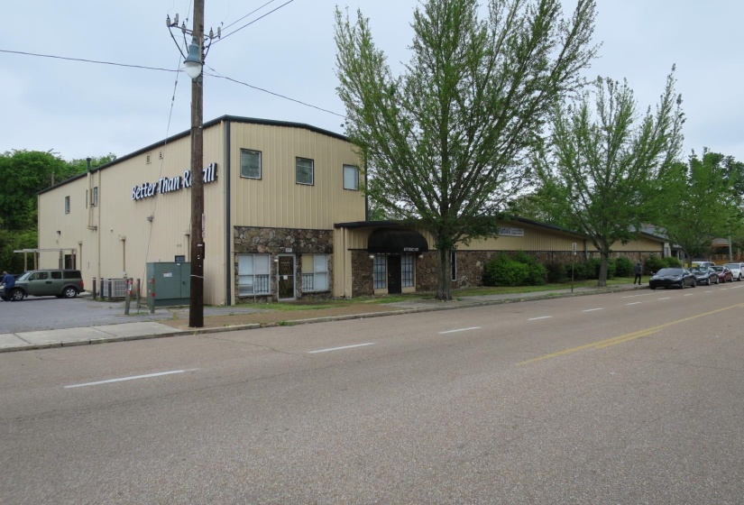 View of building exterior featuring cooling unit