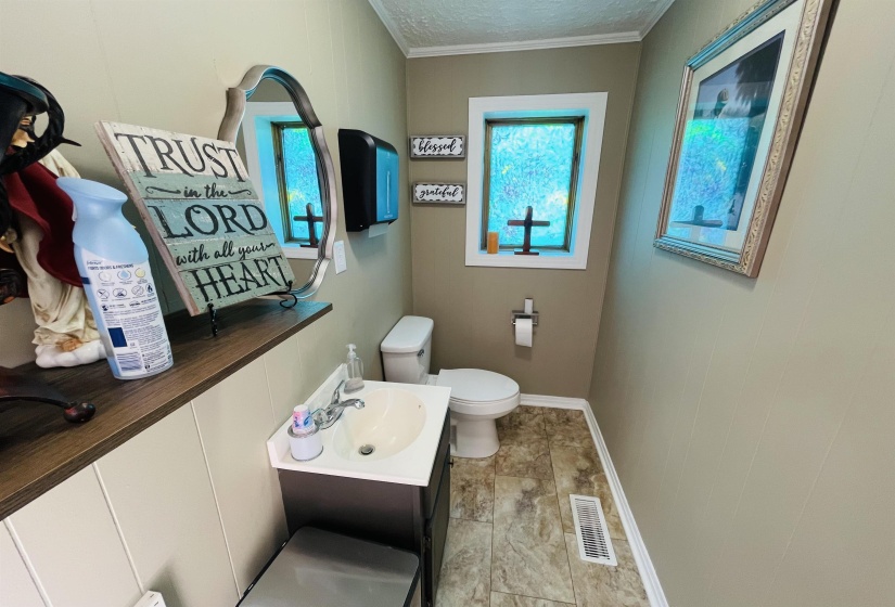 Bathroom featuring vanity, crown molding, toilet, and a textured ceiling