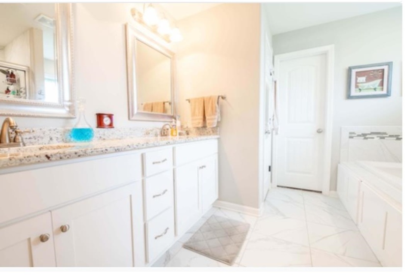 Bathroom with vanity and a bathing tub