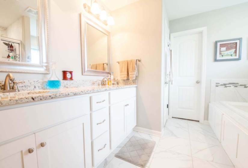 Bathroom featuring a bathing tub and vanity