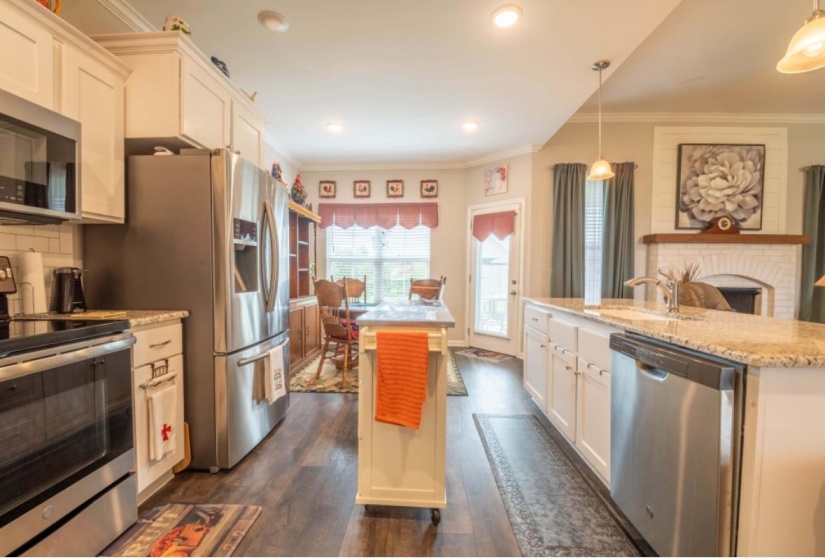 Kitchen with white cabinets, stainless steel appliances, and a center island