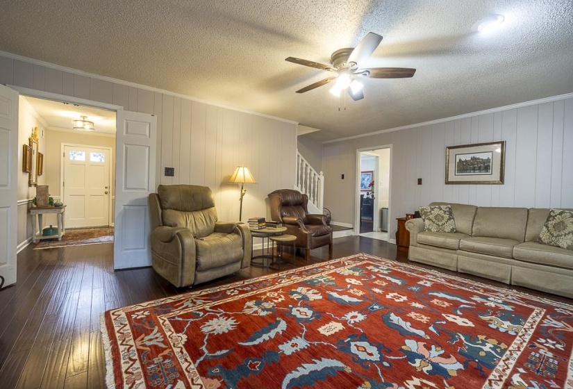 Den has beautiful hardwood floors and crown molding.
