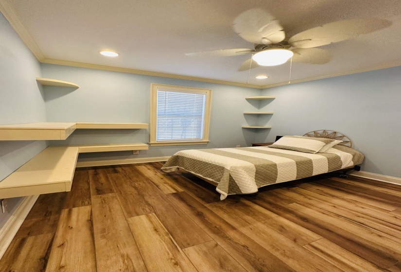 Bedroom with crown molding, recessed lighting, a ceiling fan, wood finished floors, and baseboards