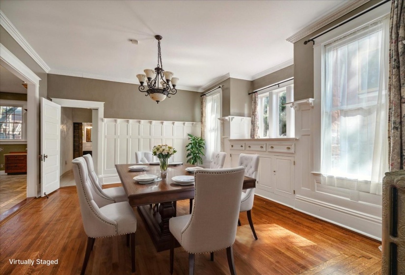 Dining space featuring a chandelier, ornamental molding, and wood finished floors