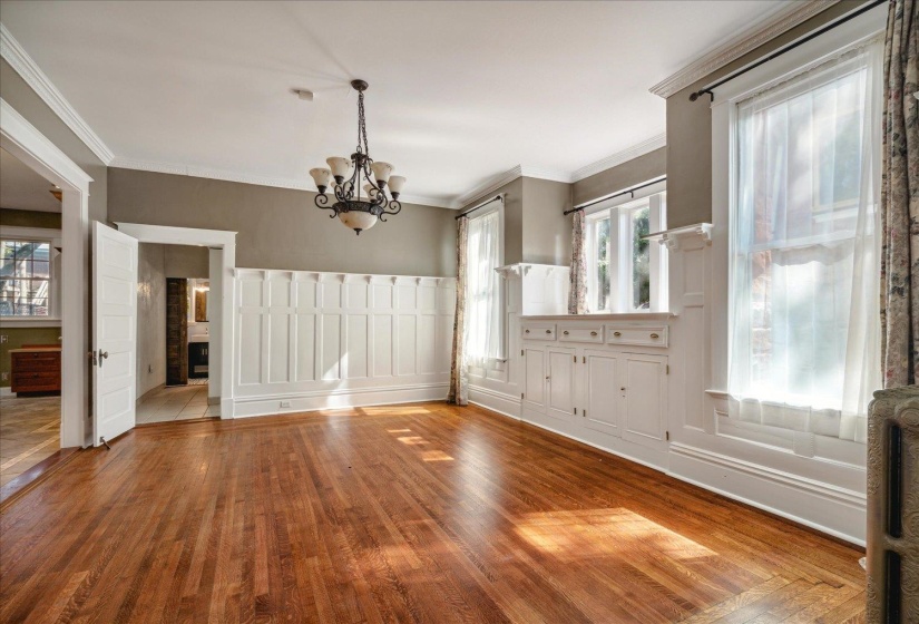 Unfurnished dining area featuring ornamental molding, light hardwood / wood-style flooring, and a chandelier